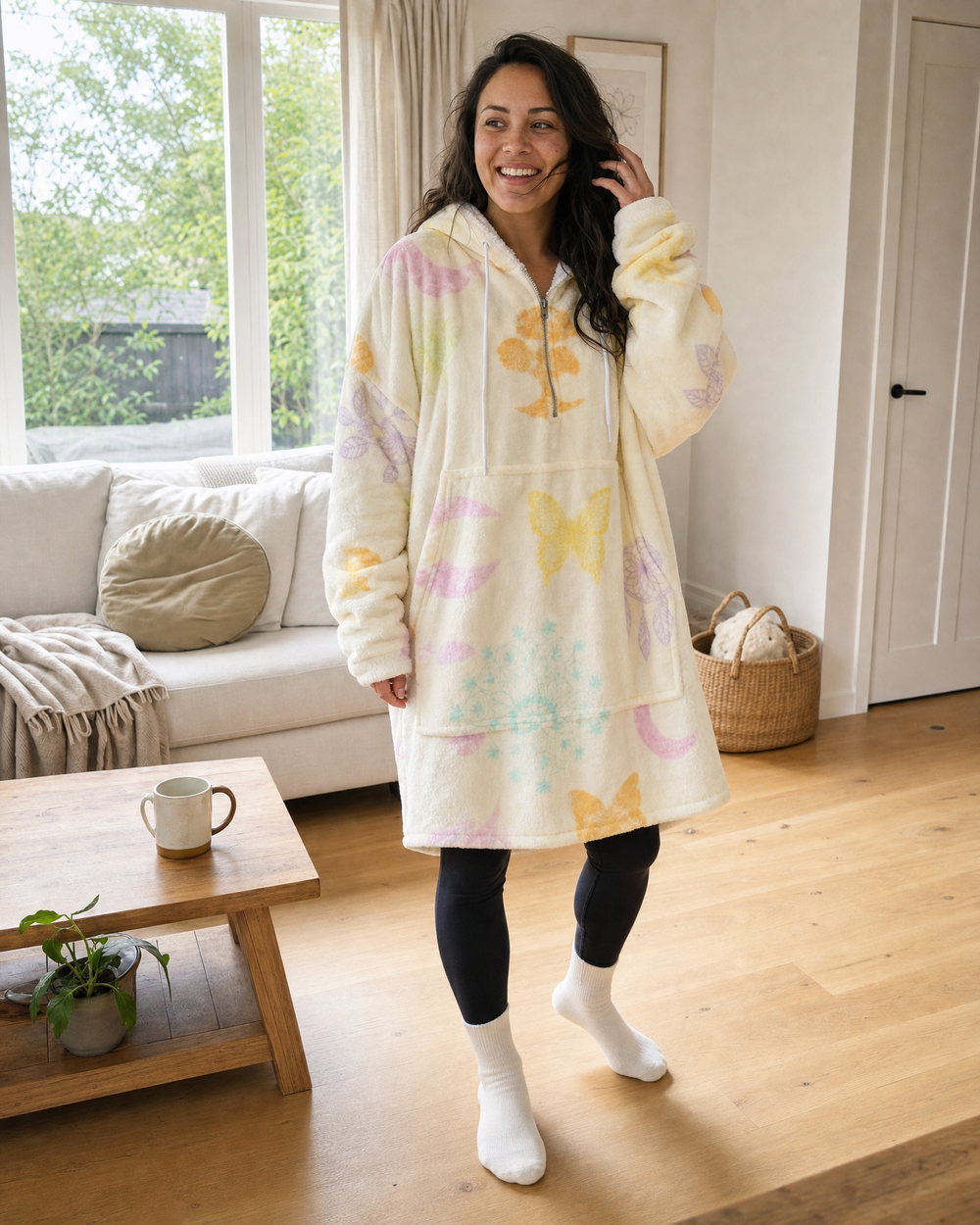Lycan Adult Yellow Mandala Blanket Hoodie, smiling model in a warm modern home
